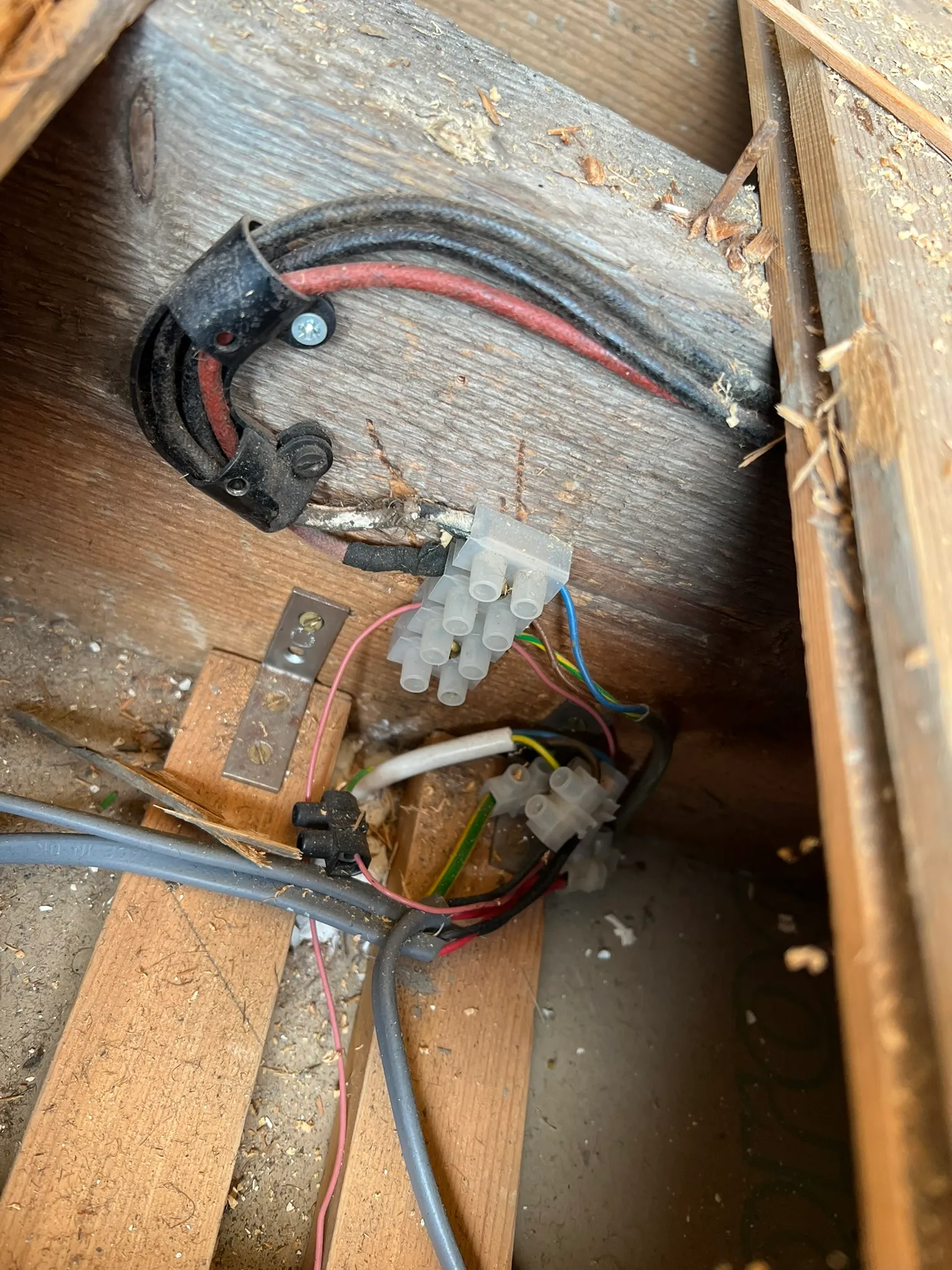 Wiring joined in exposed connector strips between wooden timbers