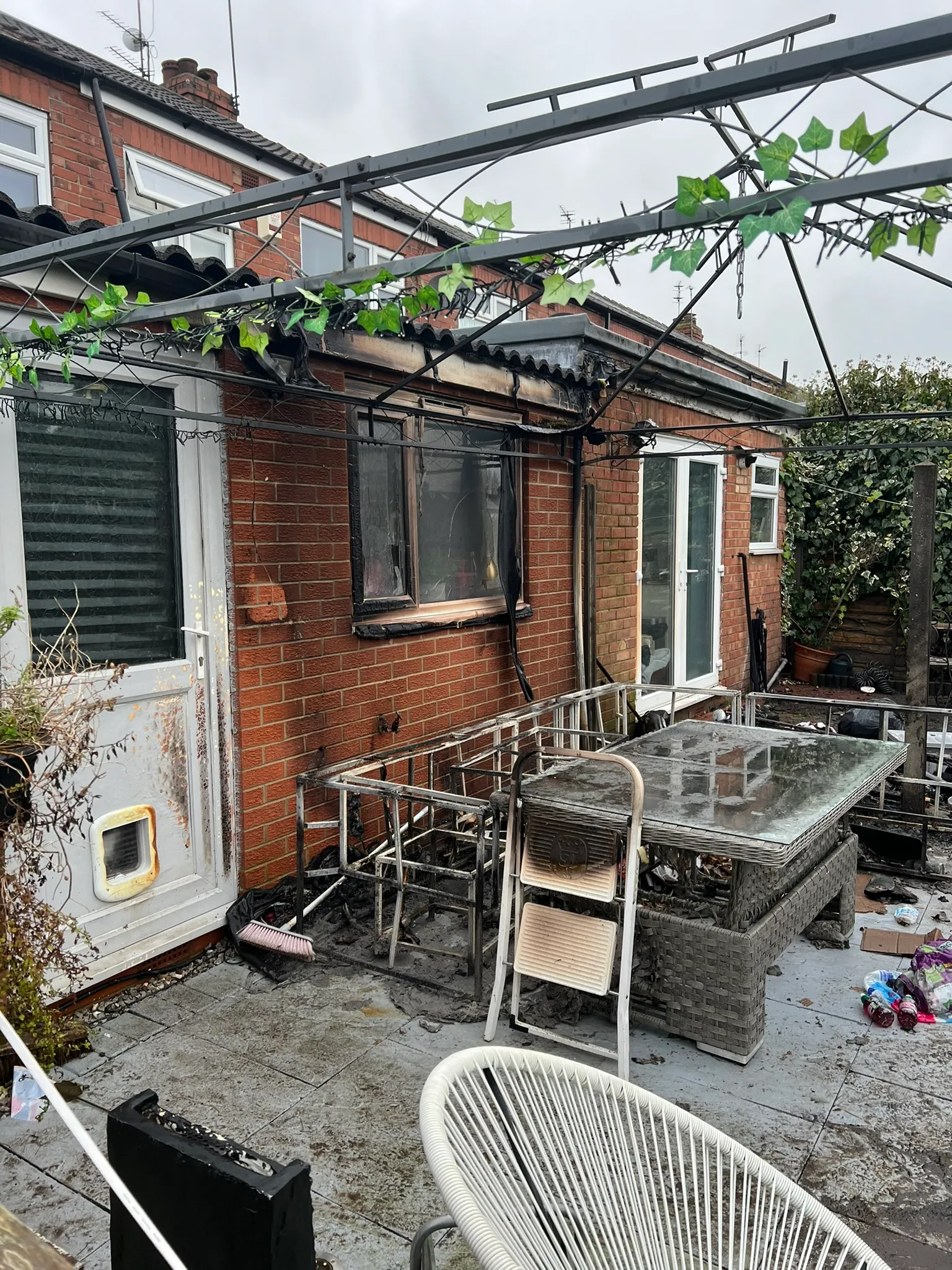Fire damage to a rear window, roof edge and patio area