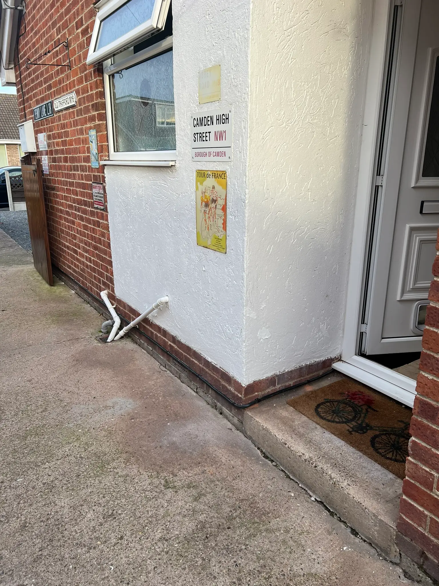 Black supply cable following the base of the outside wall and around the doorway