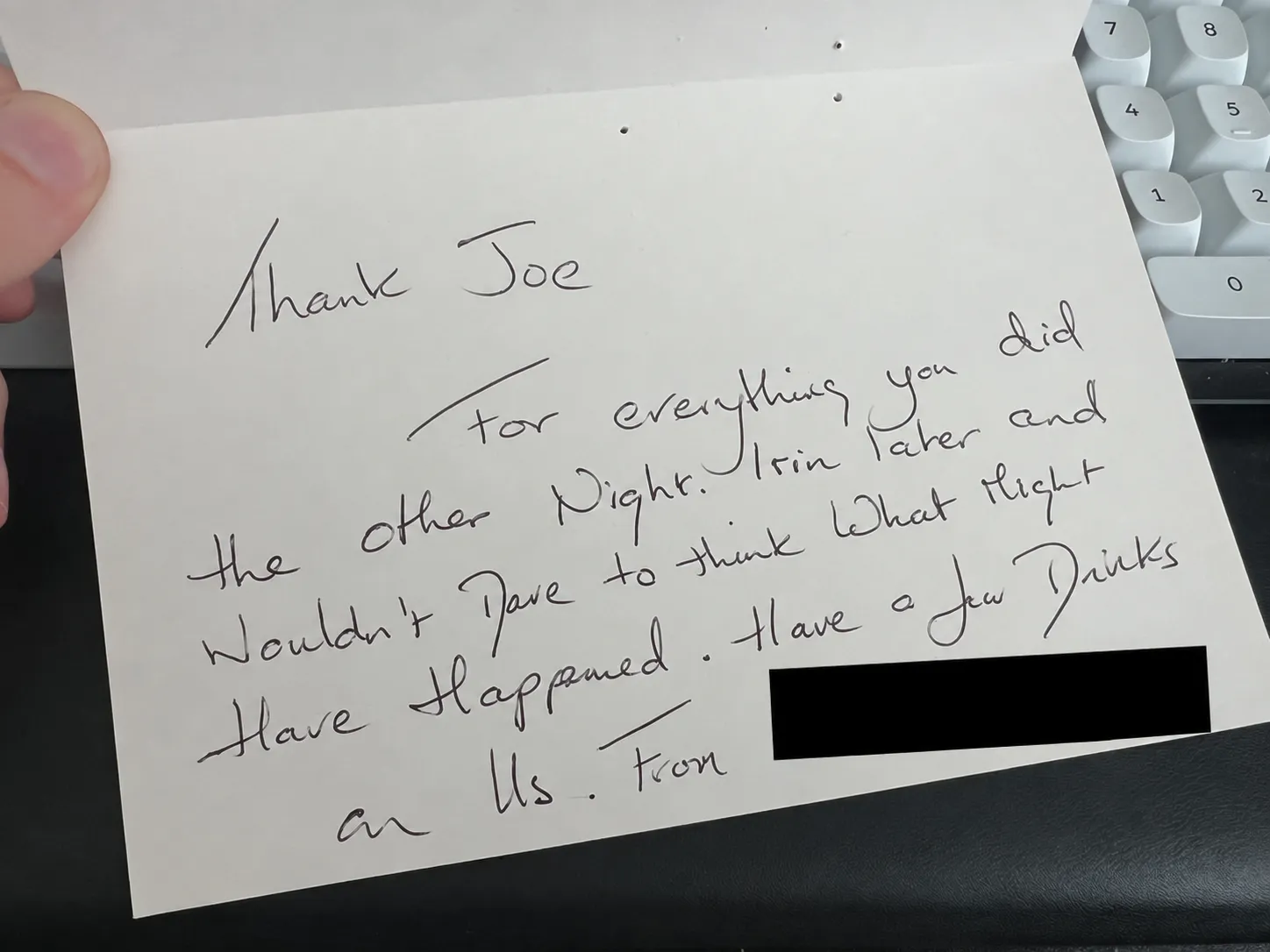 Handwritten card thanking Joe, with the senders’ names covered by a black rectangle